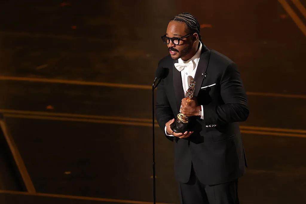 Ryan Coogler accepts the Writing (Original Screenplay) award for "Sinners" onstage during the 98th Oscars at Dolby Theatre