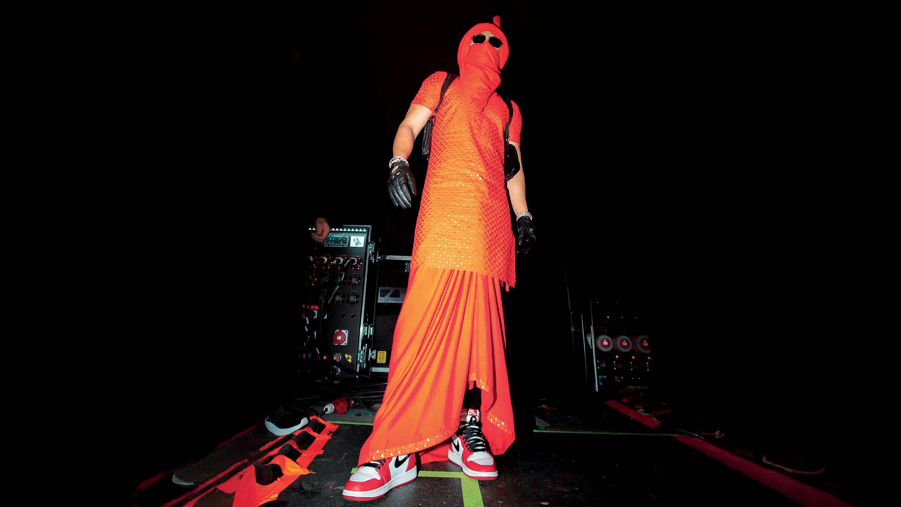 Diljit Dosanjh wearing Raghavendra Rathore on stage at his Dil-Luminati Tour.